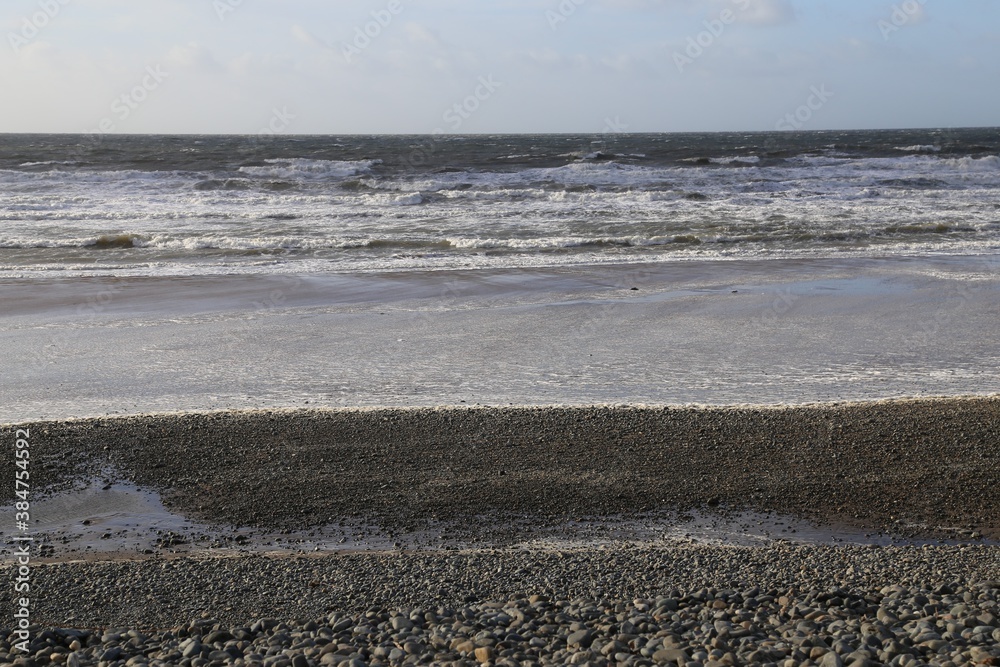 The deserted, stormy, wintry beach at Dyffryn Ardudwy, Wales, UK.