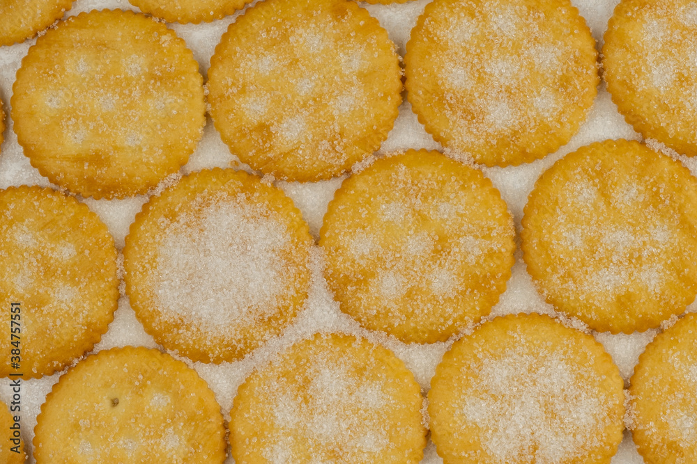 Spread of round cracker with sweet sugar isolated on white background Spread of round cracker with sweet sugar isolated on white background