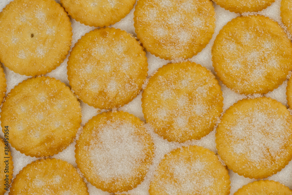 Spread of round cracker with sweet sugar isolated on white background Spread of round cracker with sweet sugar isolated on white background