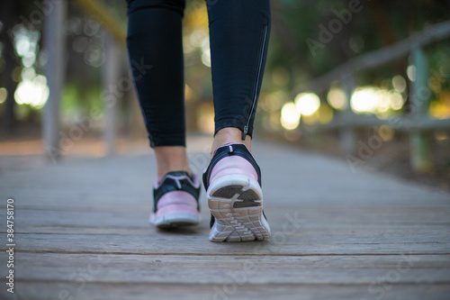 legs of a woman running through the forest