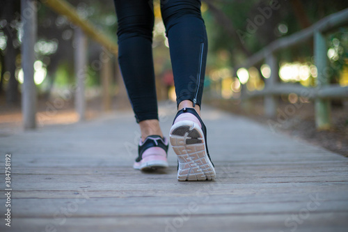 legs of a woman running through the forest