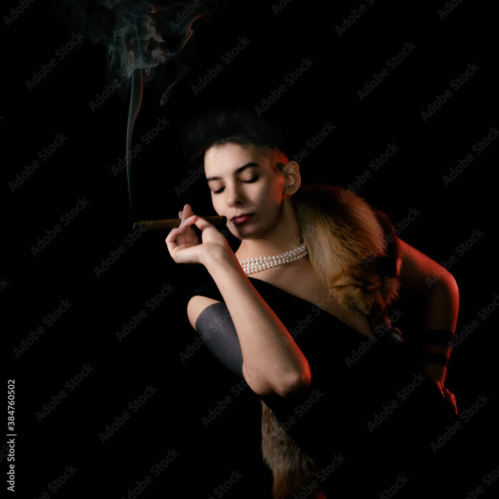 Young woman in a fur coat smokes a cigar Young woman in a fur coat smokes a cigar