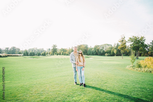 Happy young couple on green lawn