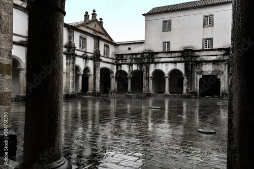 Wet Reflective Courtyard Bordered By Cloister. Templar Castle/Convent Of Christ, Tomar, Portugal.