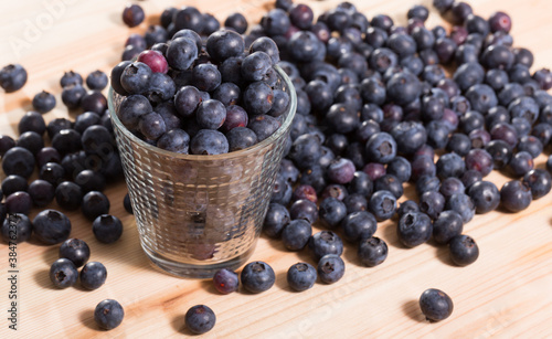 Freshly picked juicy blueberries on wooden board