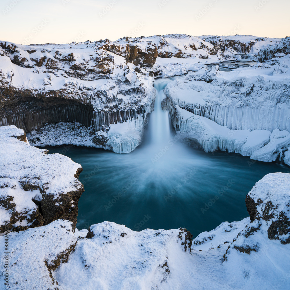 Fototapeta premium Aldeyjarfoss waterfall at sunset in winter. Columnar basalt formations around the fall. North Iceland.