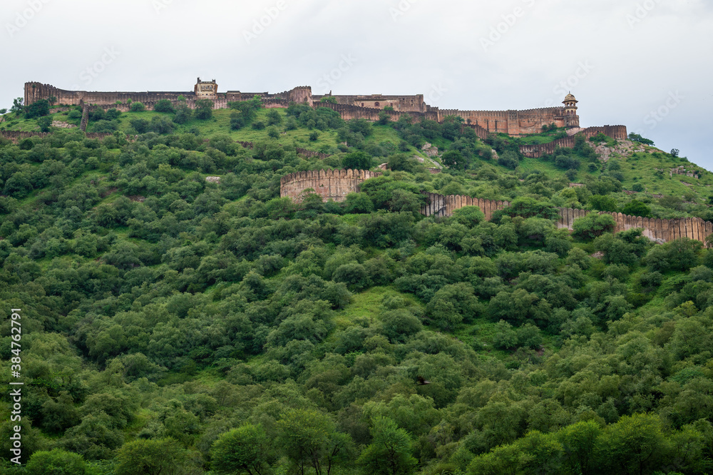 Jaigarh Fort Palace on Aravalli hill range amidst in green trees. Jaigarh Fort is a UNESCO World Heritage site