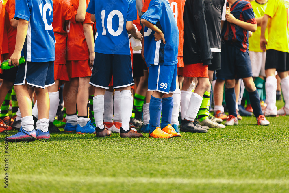 Fototapeta premium Sports Soccer Kids Teams. Many Sports Football School Age Players Standing Together on a Line. Colourful Kids Sports Clothing. Children in Football Jerseys