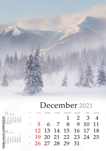 Calendar December 2021, vertical B3 size. Set of calendars with amazing landscapes. Huge snowfall in the mountain forest. Breathtaking winter scene of Carpathian mountains, Ukraine, Europe. photo