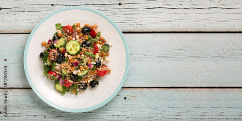 Vegetarian salad tomatoes, cucumbers, chickpeas, olives, herbs, cottage cheese, top view