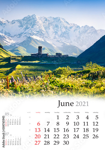 Calendar June 2021, vertical B3 size. Set of calendars with amazing landscapes. Beautiful summer view of old church in Ushgulivillage and main Caucasian ridge,Upper Svaneti, Georgia, Europe.