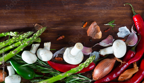 Fresh vegetables and greens on wooden background, with copyspace. Vegetarian concept photo