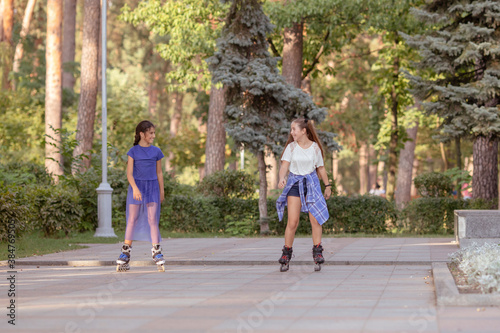 Girl rollerblading with her friend outdoors