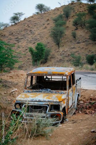 Abandoned and burnt-out car. A burnt-out car left abandoned at the road side of a quiet rural location