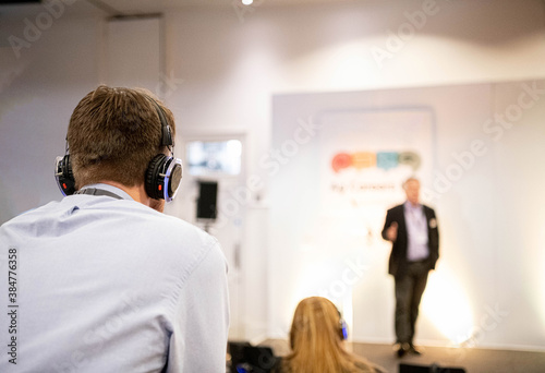 Delegates Wearing Headphones At A Business Conference Meeting