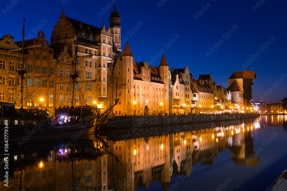 Nightlife of illuminated embankment of Motlawa river in Gdansk in summer, Poland.