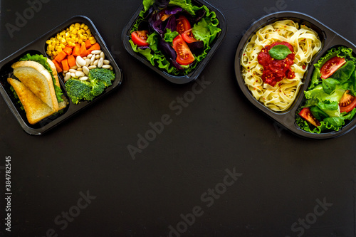 Delivery containers with takeout food on table. View from above