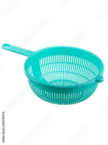 green plastic colander for cooking in the kitchen