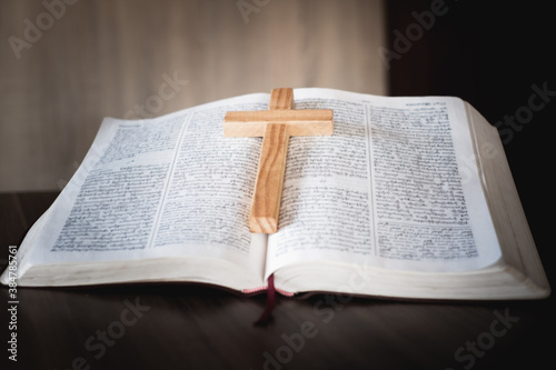 The crucifix lay on the bible. It is a blessing from God with the power and power of holiness, which brings luck and shows forgiveness with the power of religion, faith, worship, Christian thought.