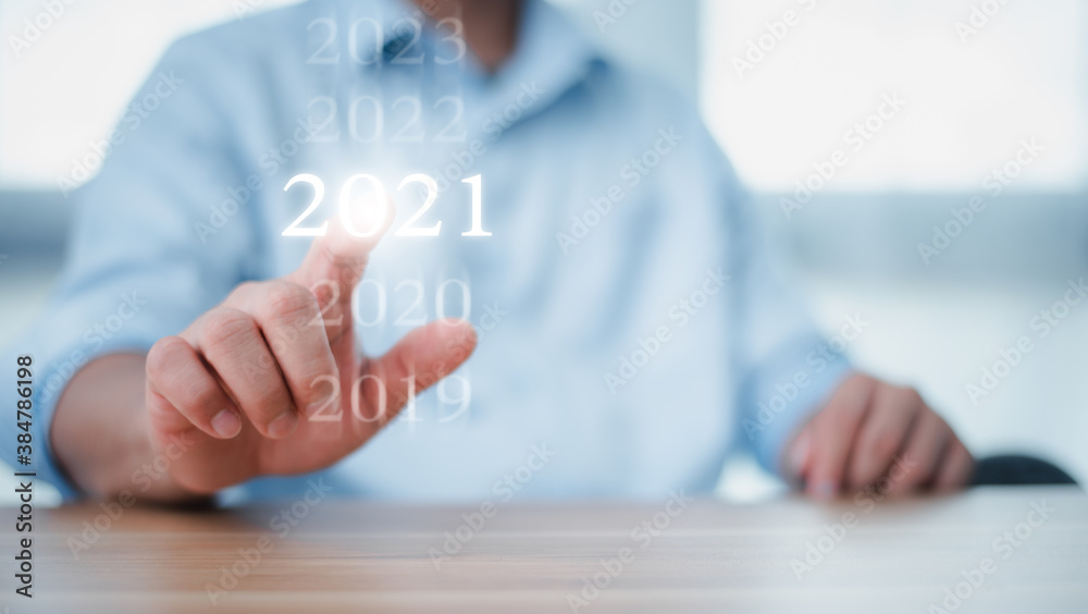 New year 2020 change to 2021 concept, hand touching on 2021 virtual screen. new years business. New year 2020 change to 2021 concept, hand touching on 2021 virtual screen. new years business.