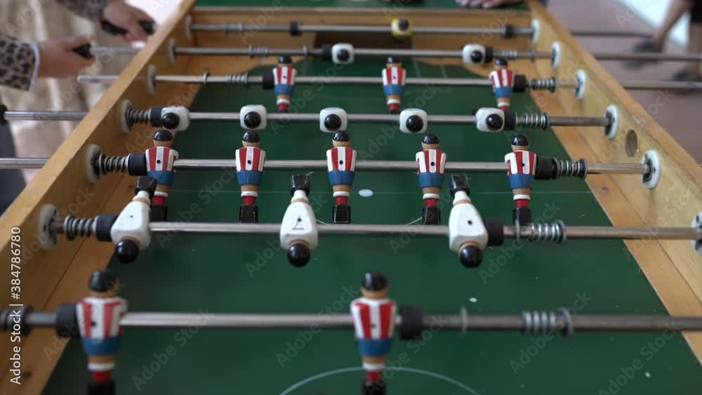 Hands of anonymous people playing table football Hands of anonymous people playing table football