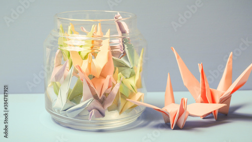 Pink paper bird in blue background