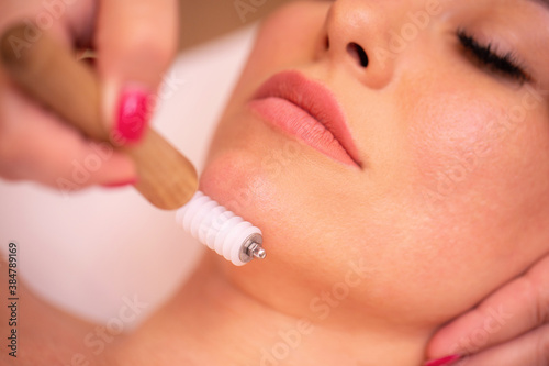 Woman having a facial madero therapy with face roller