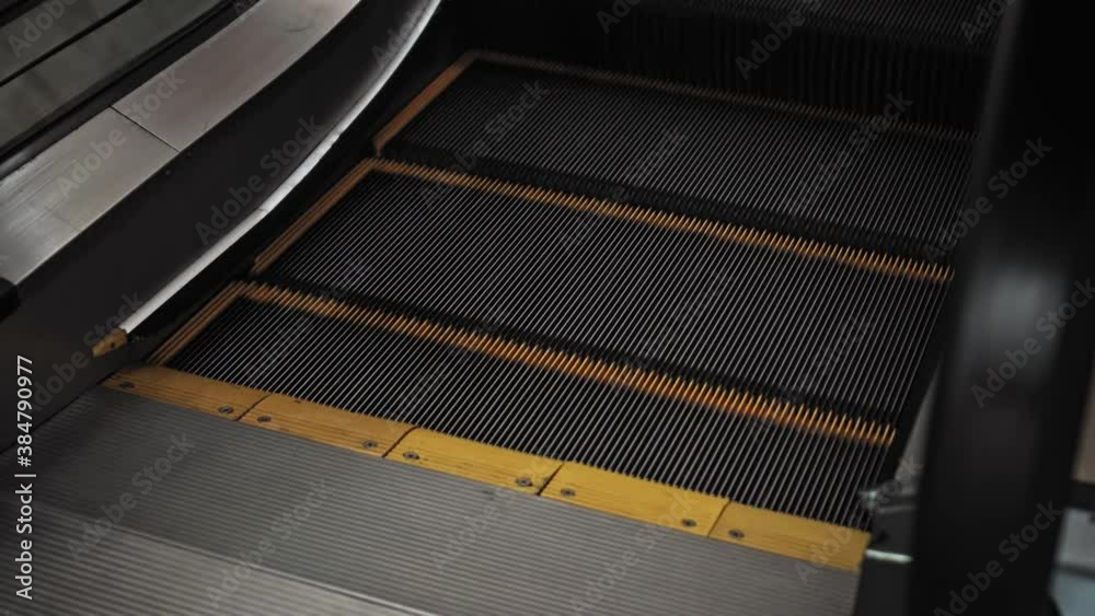 staircase escolator in a shopping center with a footprint sign for keeping a social distance staircase escolator in a shopping center with a footprint sign for keeping a social distance