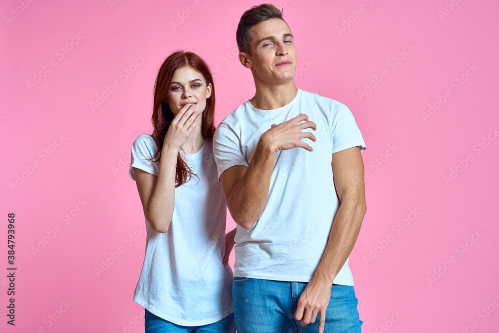 lovers man and woman in jeans and t-shirt on pink background cropped view family romance teenagers lovers man and woman in jeans and t-shirt on pink background cropped view family romance teenagers