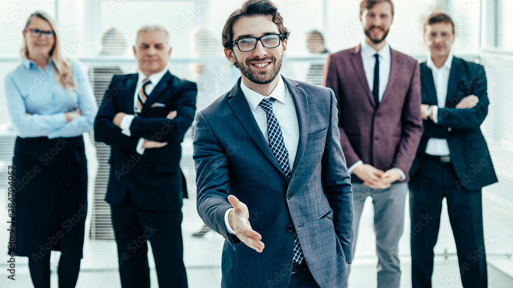 friendly businessman holding out his hand for a handshake. friendly businessman holding out his hand for a handshake.