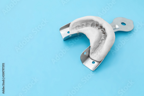 Cuadro en lienzo Dental impression of the jaw of silicone material on a blue background