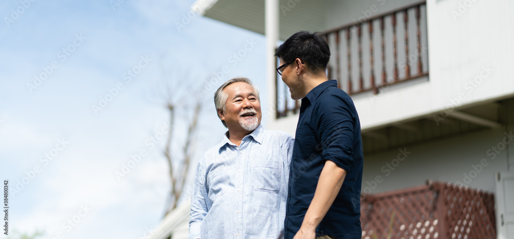 Senior Asian Father With Adult grown Son hugging outdoors Senior Asian Father With Adult grown Son hugging outdoors