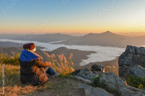 Tourists are watching the sea of mist as the sun rises in winter in northern Thailand.