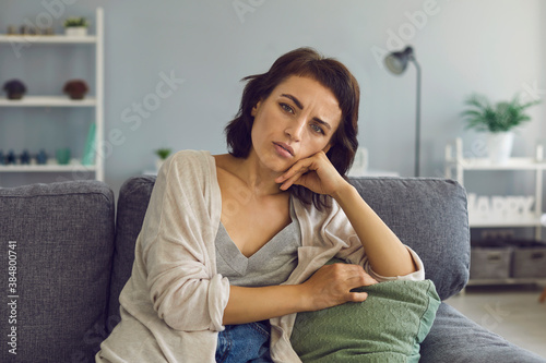 Young woman listening to somebody during online meeting