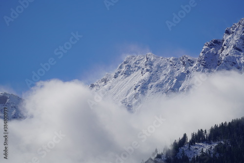 view to the alps on a foggy morning with sun and blue sky © Chamois huntress