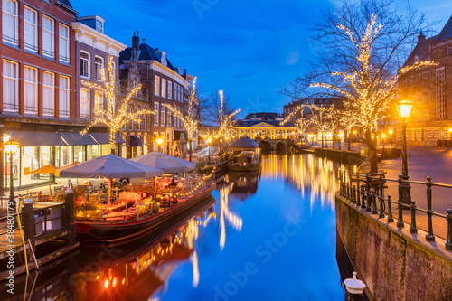 The Dutch Oude Rijn canal with bridge, historic buildings and christmas lights in the city center of Leiden © Martin Bergsma