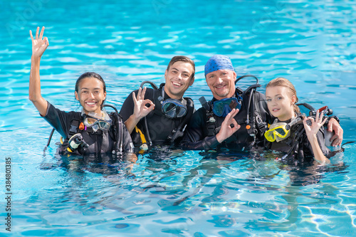 A group of people practice scuba diving in the pool. Diving as an extreme sport