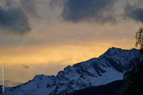 beautiful sunset on the mountains with clouds and orange sky