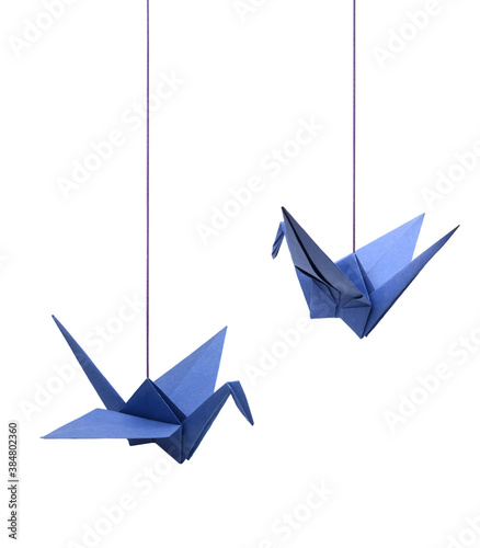 a haning blue origami bird paper on white photo