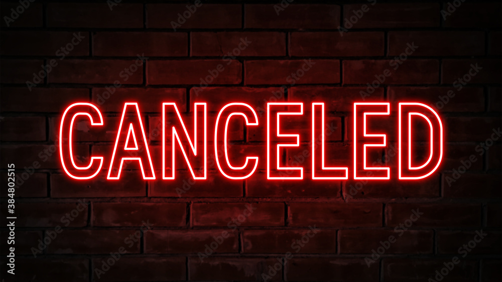 Canceled - red neon light word on brick wall background