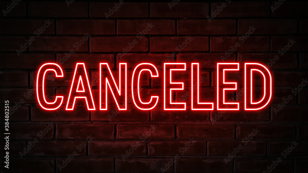 Obraz premium Canceled - red neon light word on brick wall background