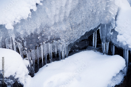 Row of frosty icicles in nature