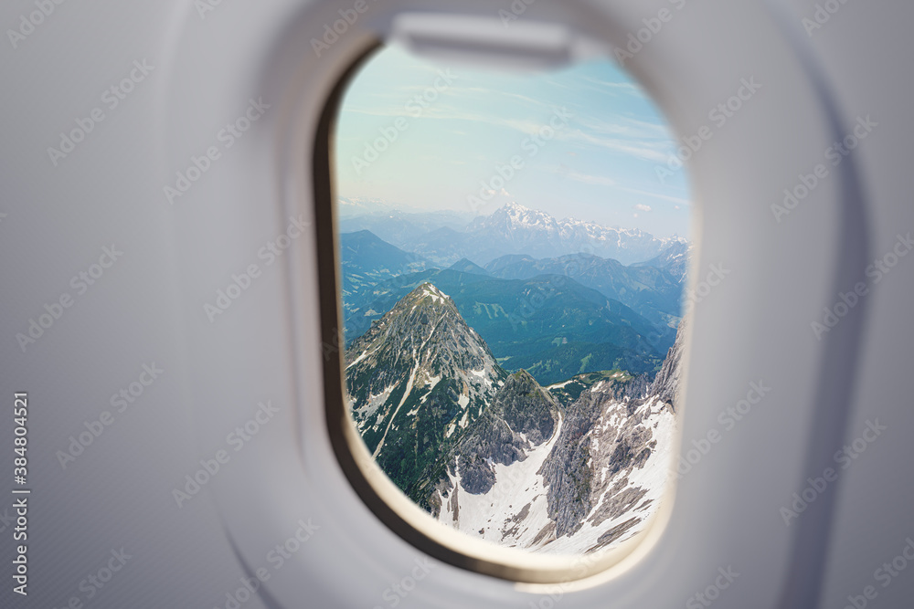 Naklejka premium View from airplane window on Alps mountains.