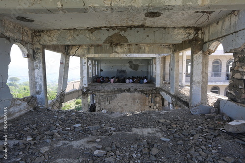 Children study in a school destroyed by the war in Yemen, Taiz