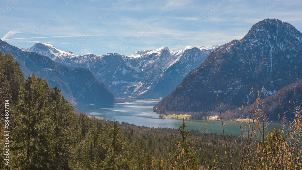 Panoramic view on Austrian mountains Alps lake Hallstattersee. Blue sky snowy mountains scenic landscape.