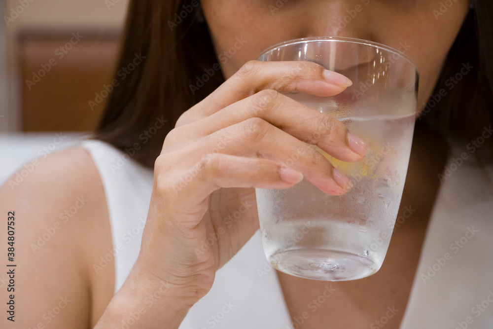 Close up of women eating natural water in glass Close up of women eating natural water in glass