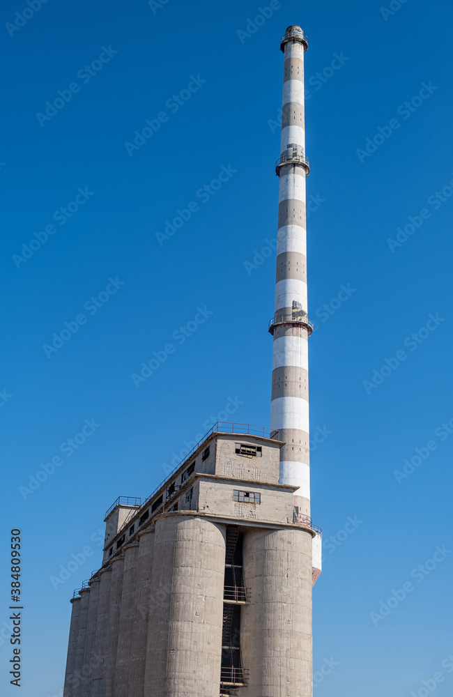 Old fertilizer plant silo and chimney in Drapetsona Piraeus Greece, sunny day. Old fertilizer plant silo and chimney in Drapetsona Piraeus Greece, sunny day.