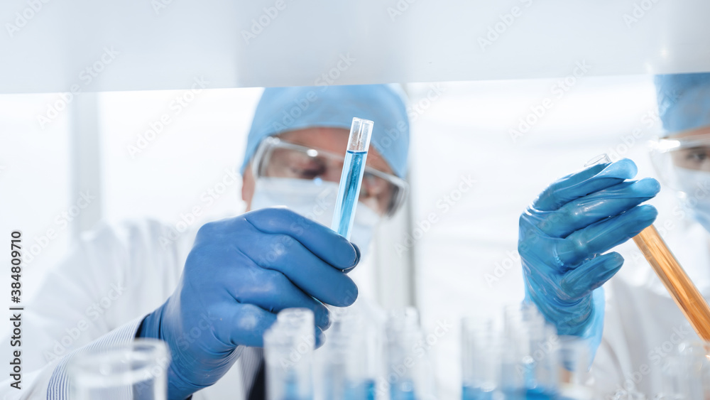 close up. scientists with test tubes in a biochemical laboratory . close up. scientists with test tubes in a biochemical laboratory .