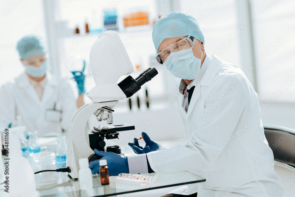 close up. ambitious scientist sitting at a laboratory table . close up. ambitious scientist sitting at a laboratory table .