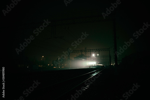 Night train in the fog. A ray of light